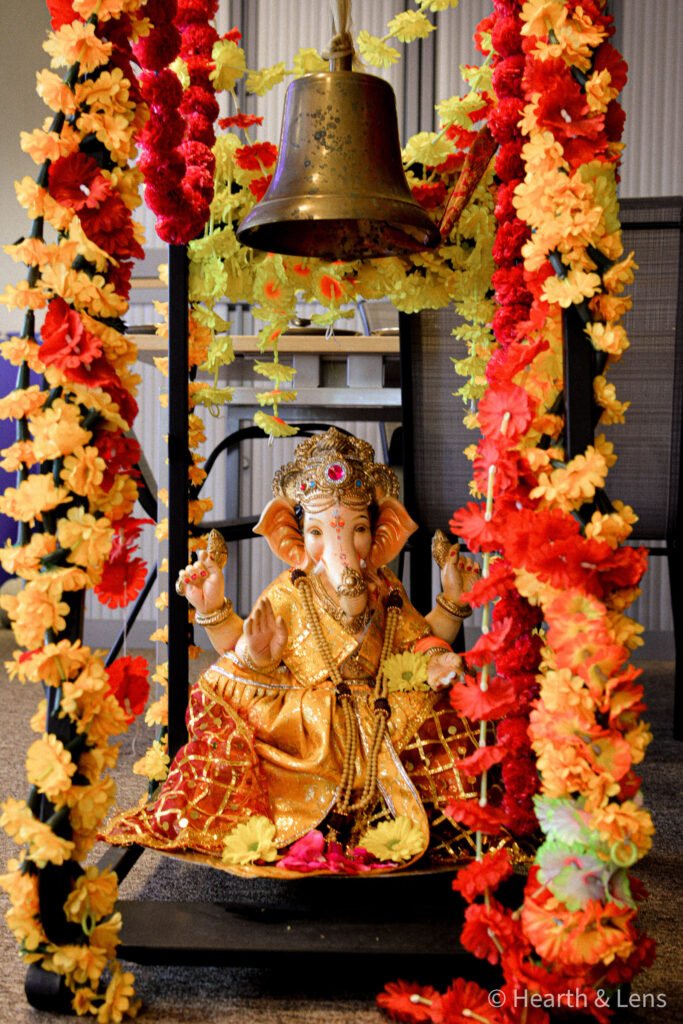 Decorated statue of Lord Ganesha surrounded by flowers during the Janmashtami celebration at Dharma Mandir Newport.