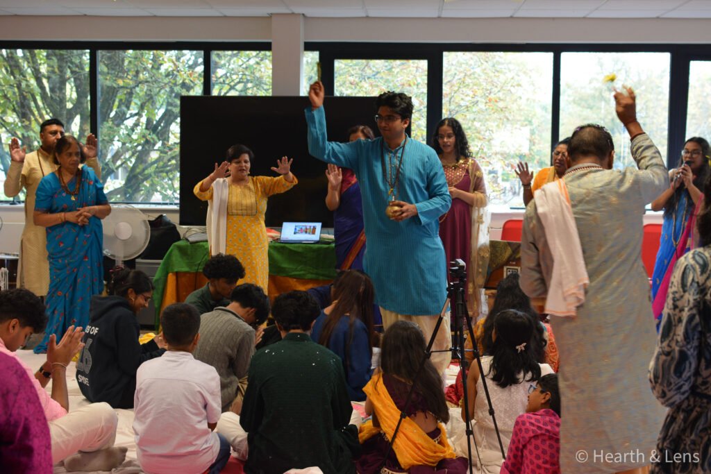 Elders offering blessings to children during the Janmashtami celebration at Dharma Mandir Newport.