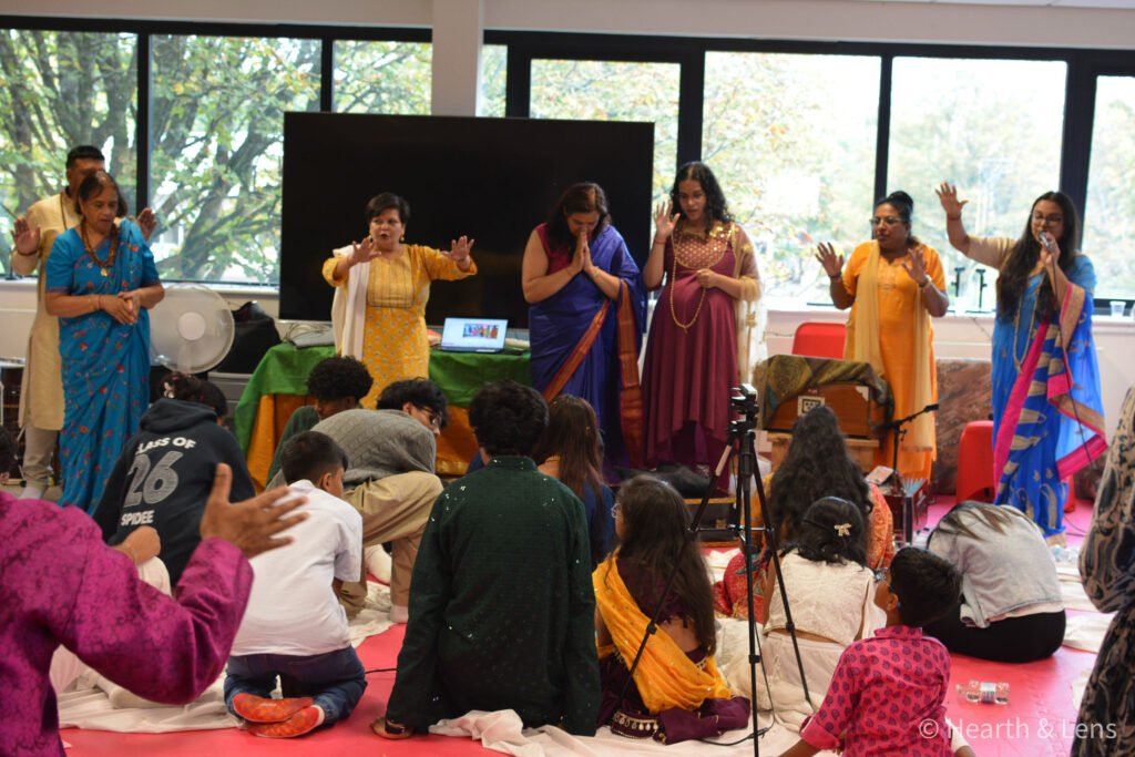 Children and families gathered for Vedic prayers and blessings during the Janmashtami celebration at Dharma Mandir Newport.