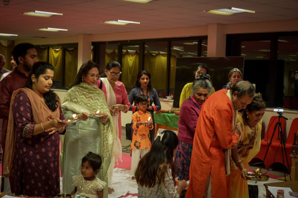 Devotees gathering together for Samuhik Aarti at Dharma Mandir Newport