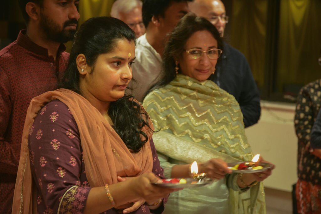 A devotee participating in the collective aarti during Ganesh Chaturthi in Newport